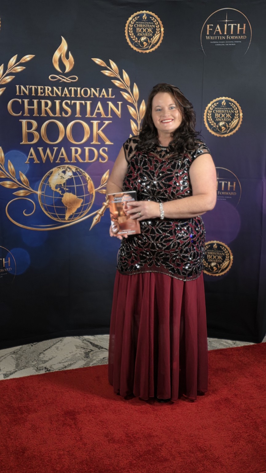 Johanna Vendel holding Unseen Tears, Beneath the Mask at the International Christian Book Awards